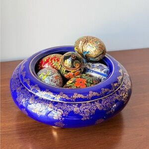 Beautiful ceramic royal blue bowl with golden details
Filled with painted eggs.
